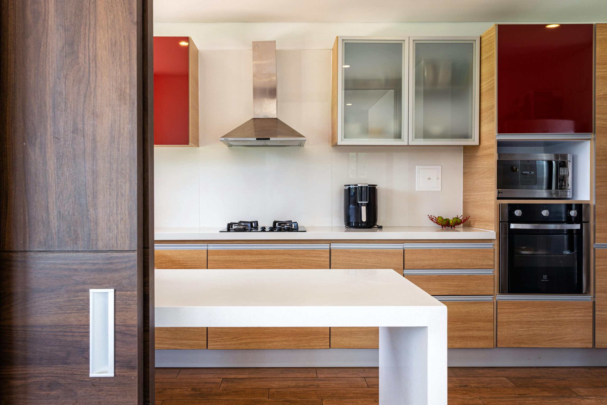 Home Stylish kitchen featuring wooden cabinets, glossy surfaces, and modern appliances.